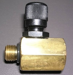 A close-up of the Indmar TOOL FUEL PRESSURE ADAPTER 6.2L FORD - 605121FP, featuring a threaded male connection and black plastic knob, designed for 6.2L Ford engines, placed on a gray surface. Brand: Indmar.