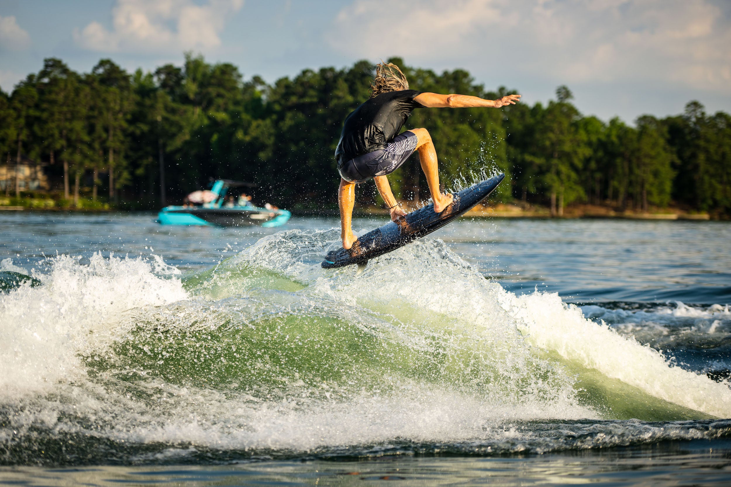 A man is riding a wave on a Hyperlite 2023 Ranger Wakesurf Board.