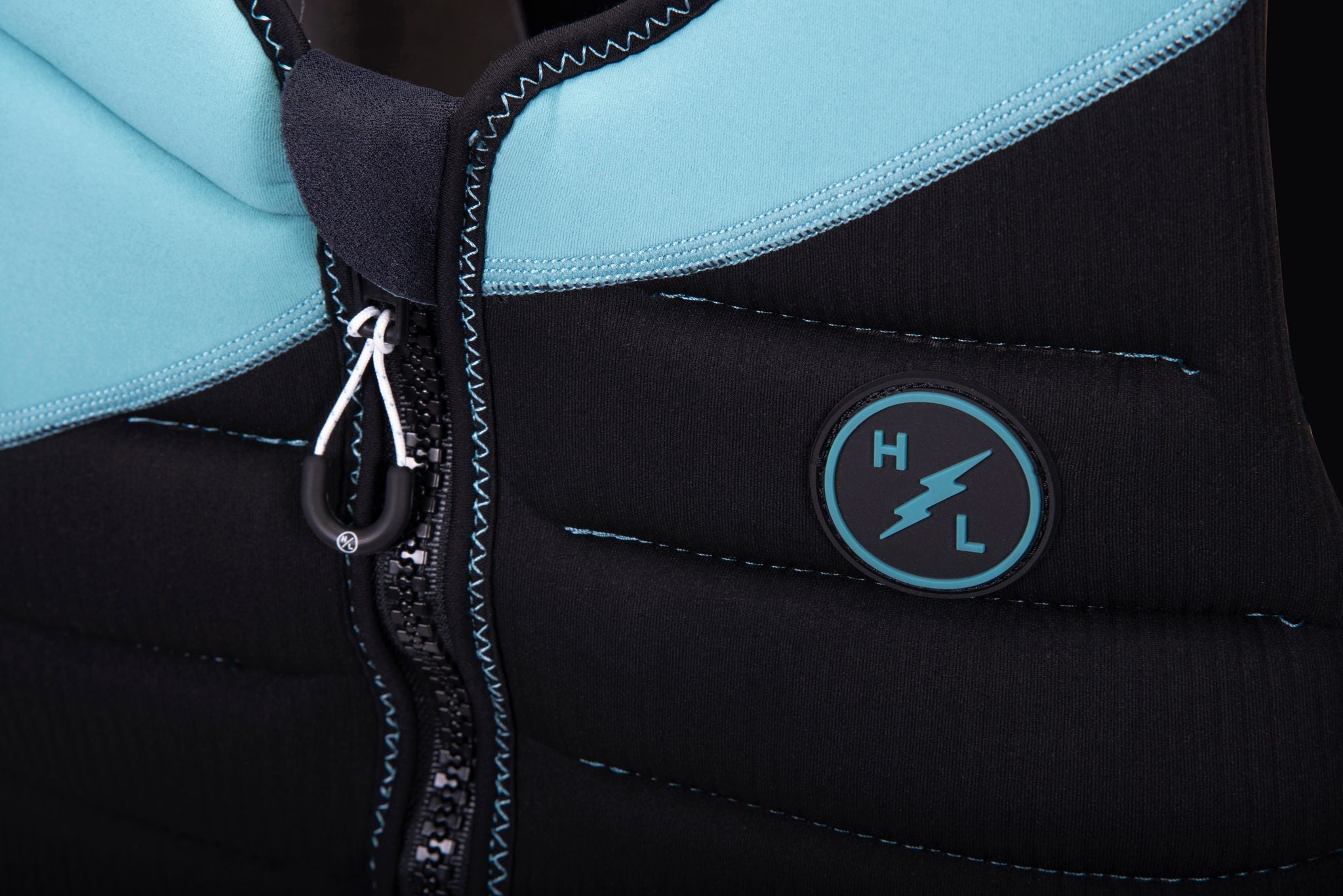 A black and blue Hyperlite 2024 NCGA Storm Vest with a blue zipper.