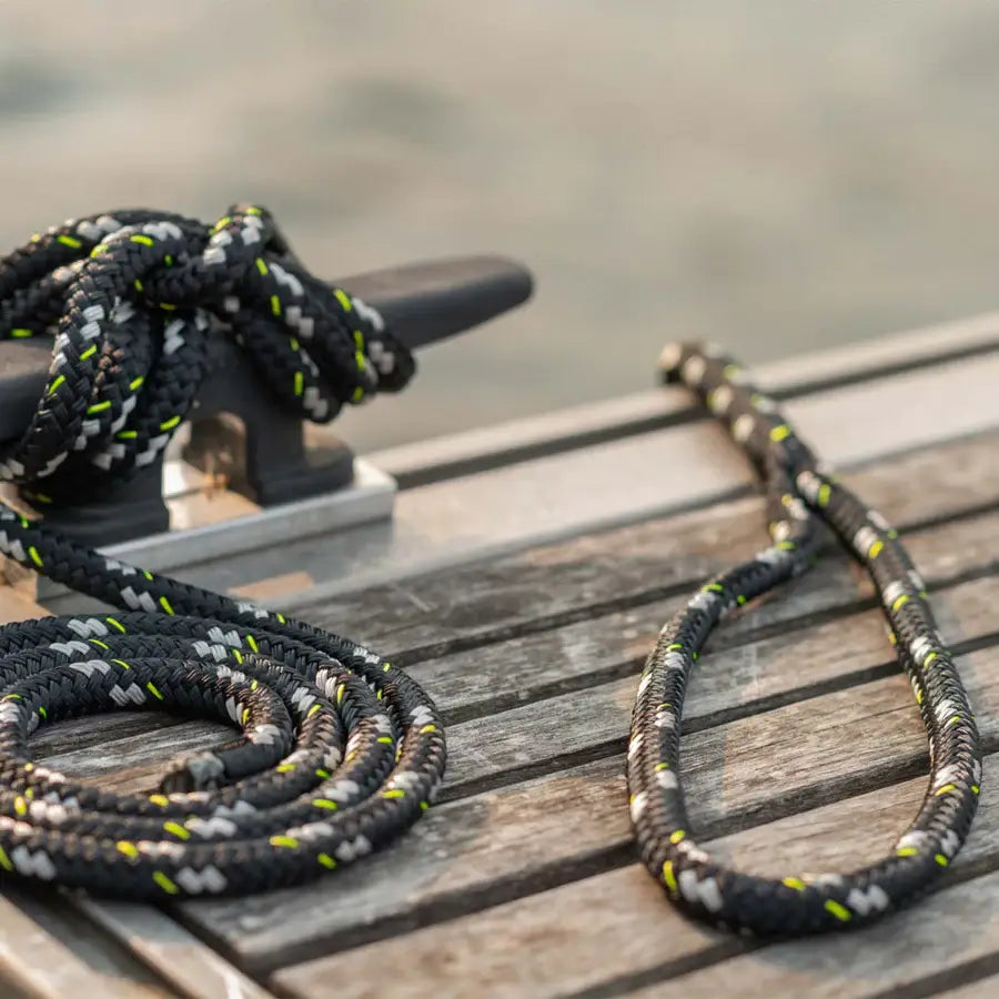 Two MISSION double braided dock lines next to a boat on a wooden dock, known for their high strength.