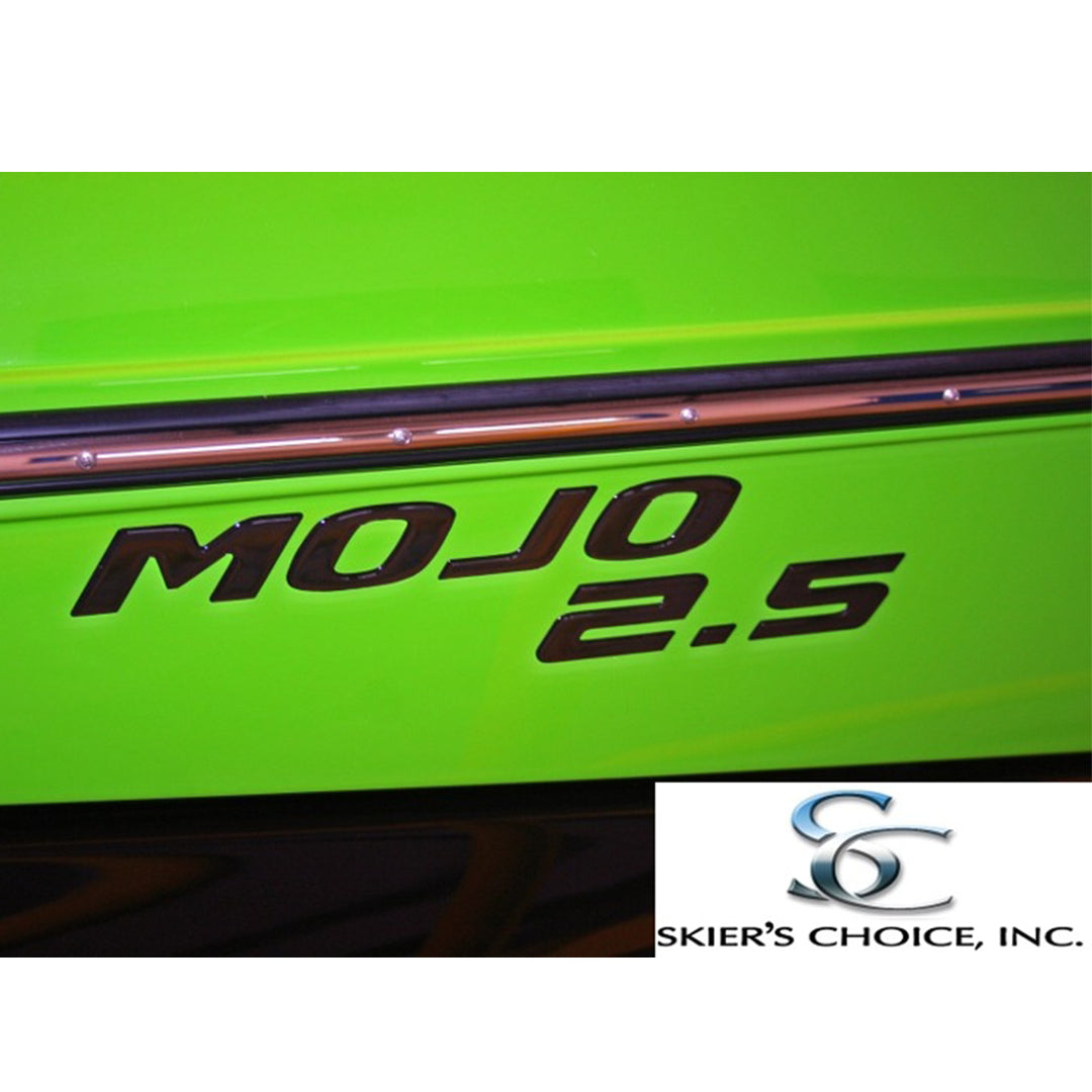 Close-up of a bright green boat featuring the Moomba Mojo 2.5 Black Chrome Transom Decal (114191) with metallic trim. The brand name Moomba and the Skiers Choice, Inc. logo appear at the bottom right.
