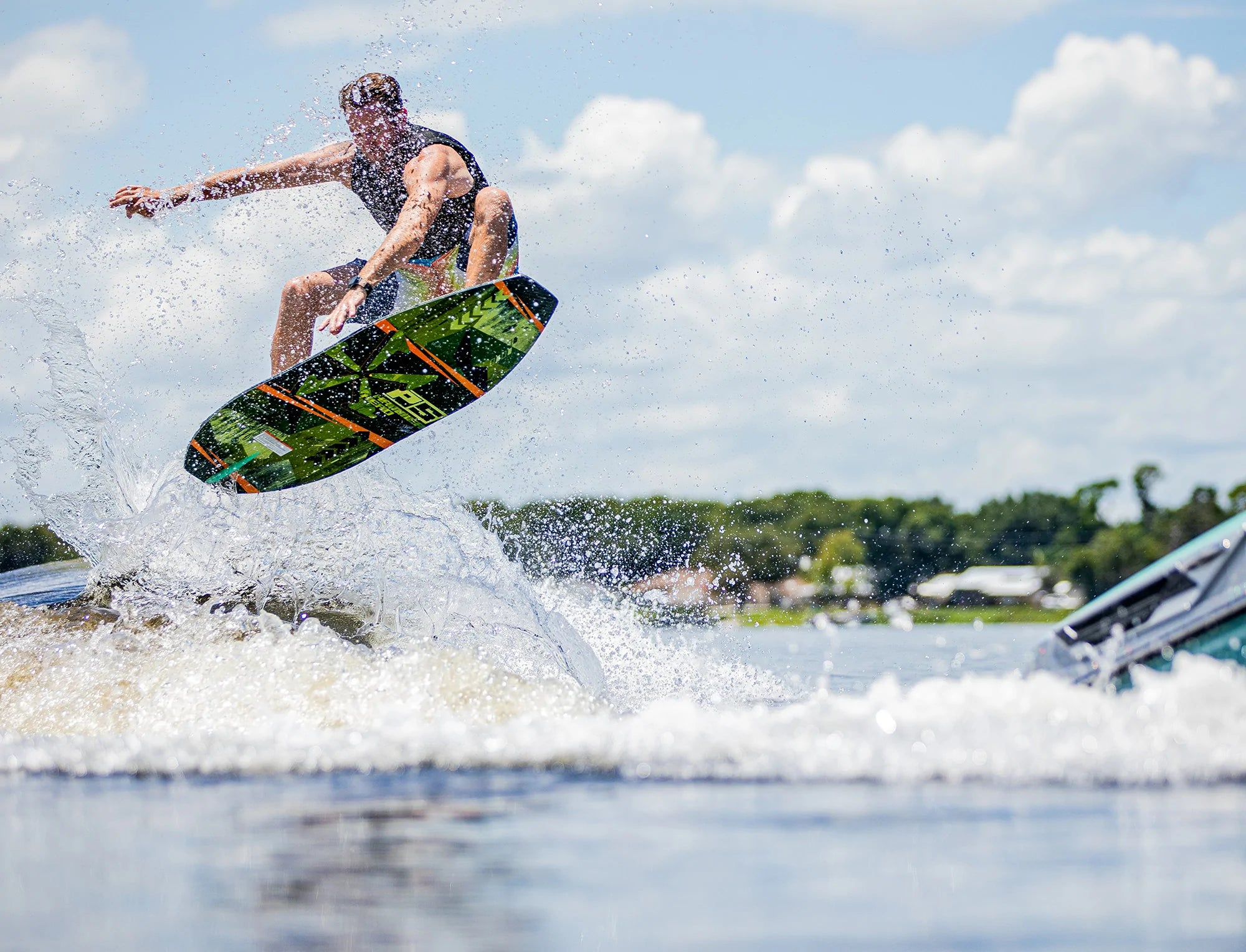 A man is riding a maneuverable Phase 5 2023 Hammerhead Wakesurf Board in the air, showcasing his skim style and resembling a Hammerhead.