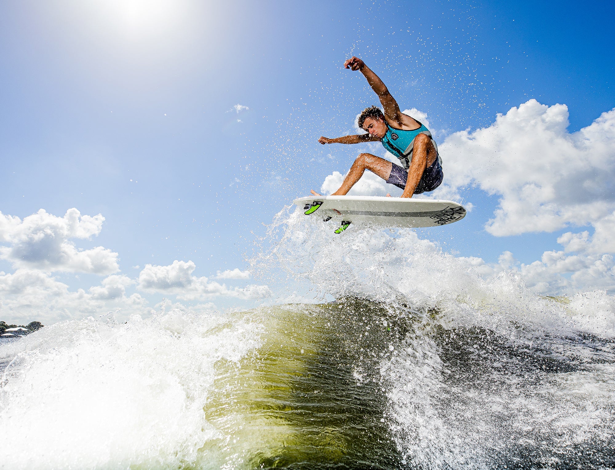 A man is riding a wave on a Phase 5 2023 Phantom Wakesurf Board, effortlessly gliding through the water.