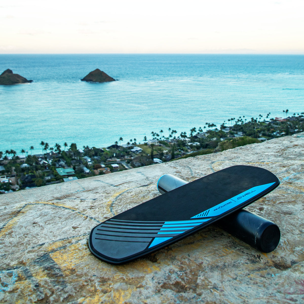 A Revolution Swell 2.0 Balance Board balanced on top of a rock.