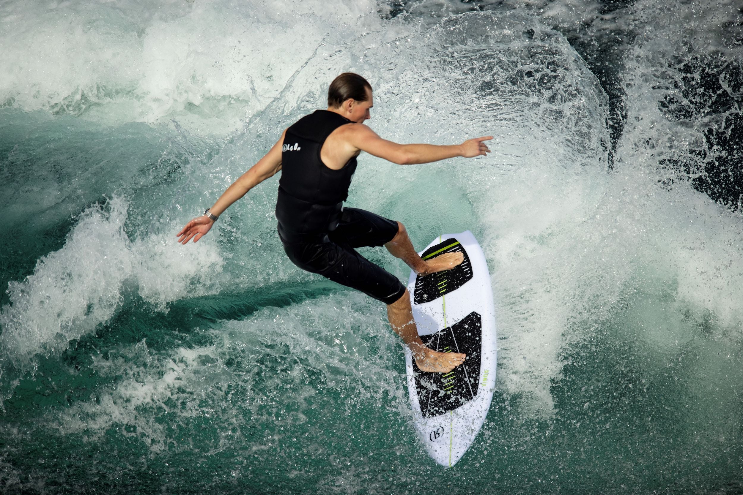 A surfer riding a wave on a Ronix 2023 Flyweight Conductor Wakesurf Board, demonstrating their exceptional speed and skill in surfing.