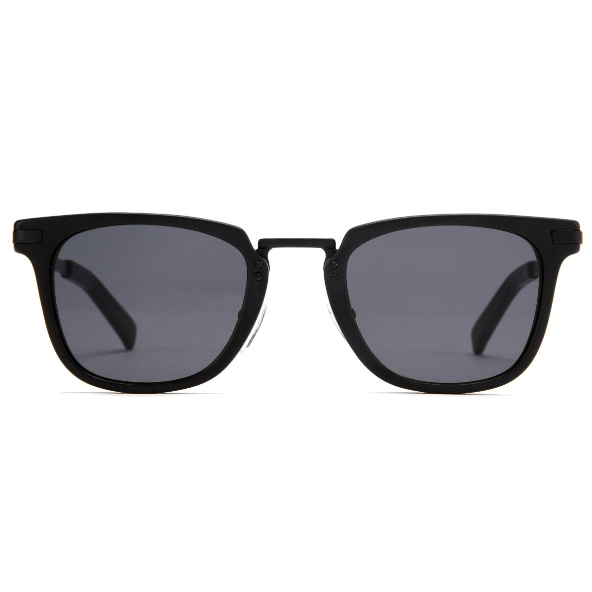 A pair of Otis the Talk sunglasses by Otis, featuring a matte black rectangular frame and grey polarized lenses with UV protection, displayed from the front against a light gray background.