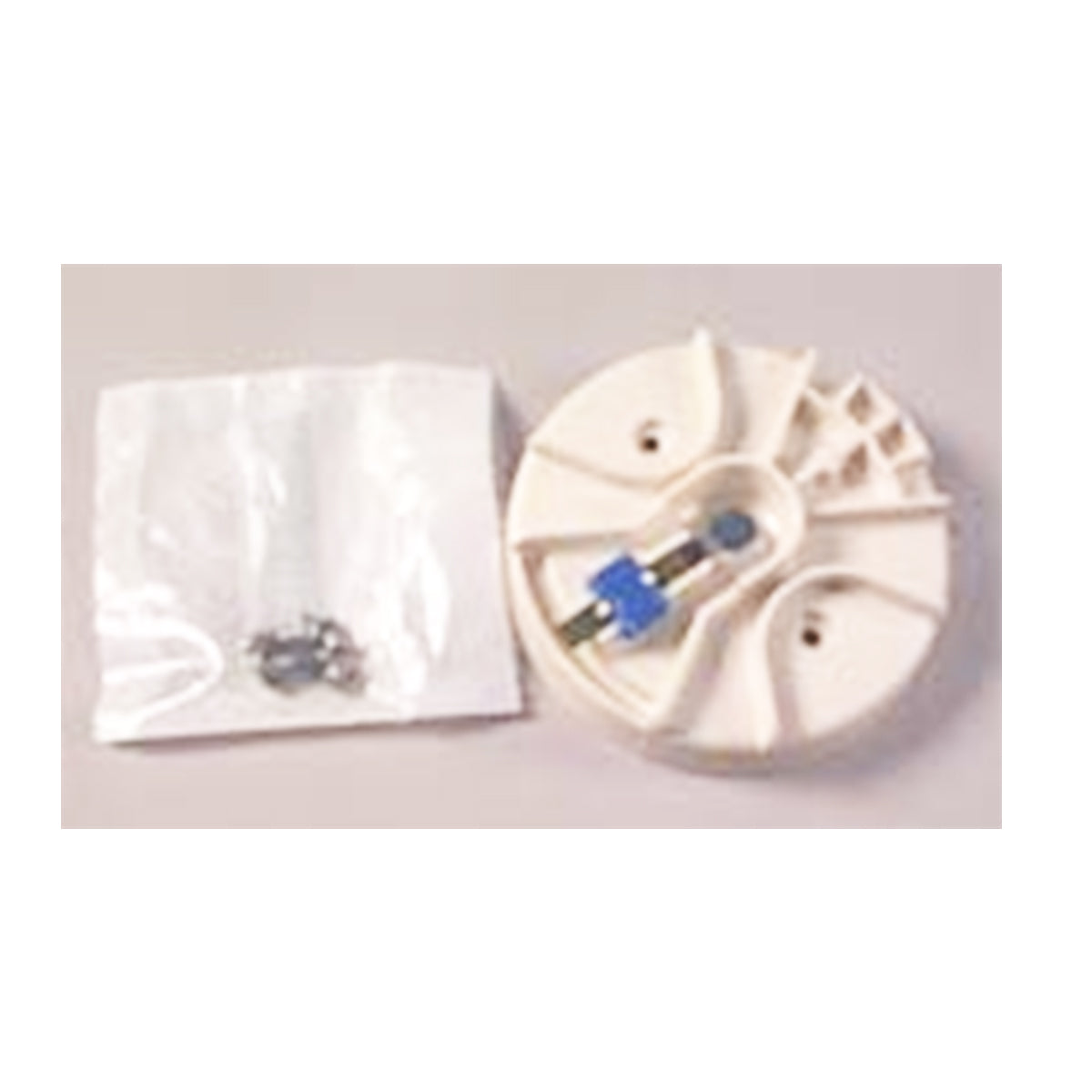 A round, white plastic mounting base holds a blue Indmar ROTOR HVS (HIGH VOLTAGE SWITCH) - 556346 in the center, next to a sealed bag of screws.