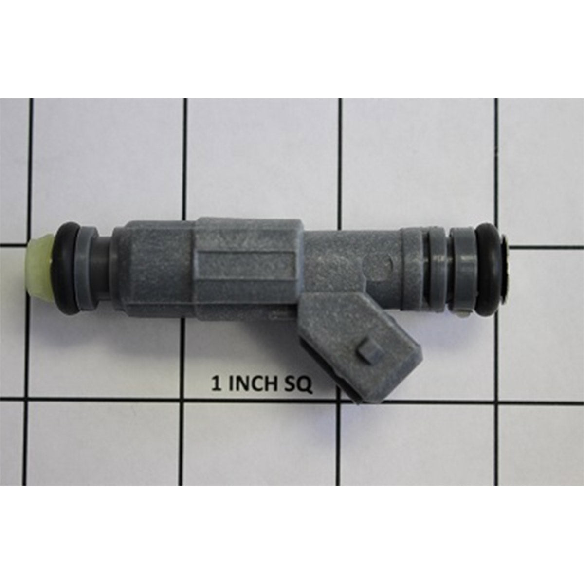 A gray Indmar INJECTOR FUEL 4 BAR (EV6) - 636049 connector with rubber rings on both ends, shown on a 1-inch grid, measures about 3 inches long.