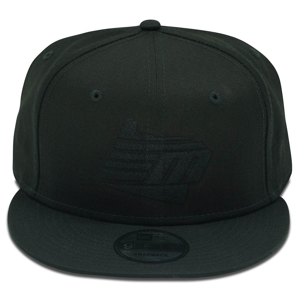The Malibu Oregon Black/Black New Era 9FIFTY Snapback features a flat brim, subtle front embroidered logo, and a sticker on the brim, showcasing the classic Malibu style.