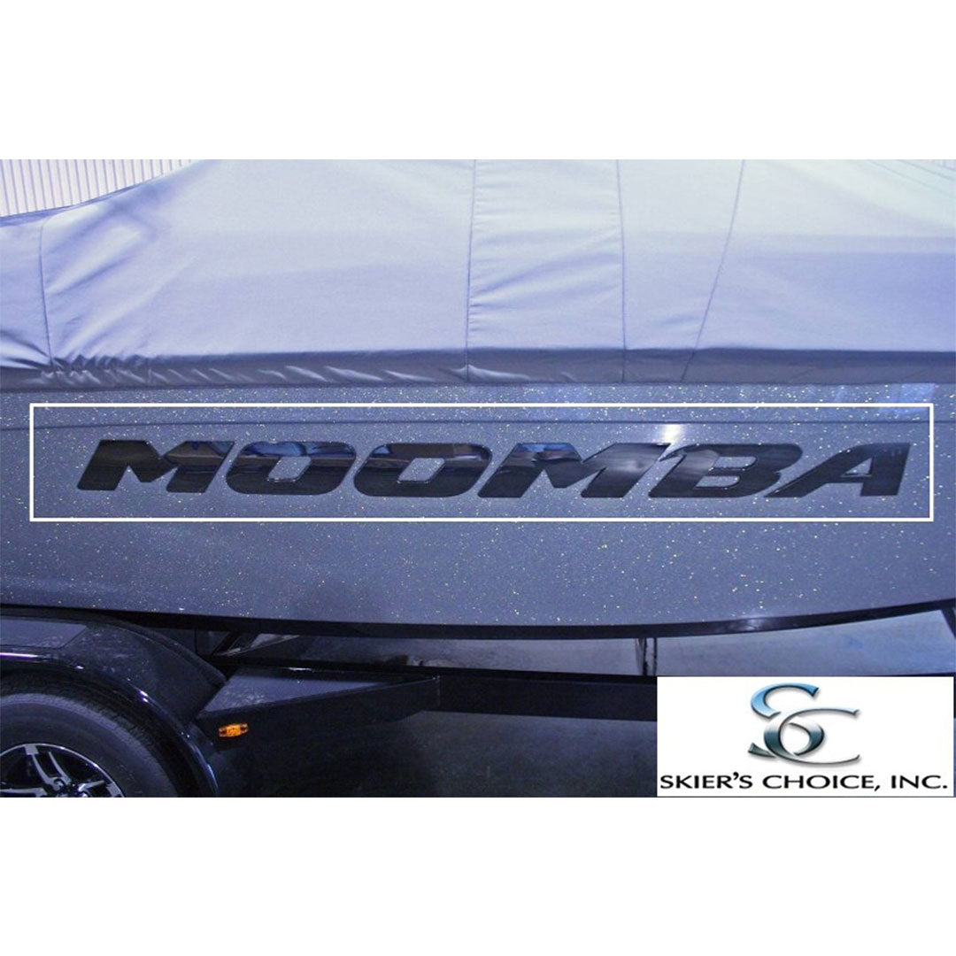 A close-up shows the Moomba Chrome Badge, Hull Decal (110150) from Moomba in bold on the boat's hull; a trailer wheel and the Skiers Choice, Inc. logo are partially visible.