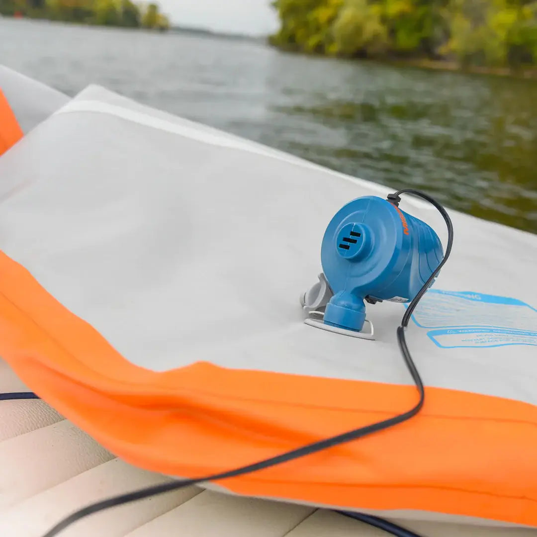 An inflatable MISSION bag with a MISSION 12V DC Low Pressure Pump attached to it for easy inflation using a 12v accessory power adapter.