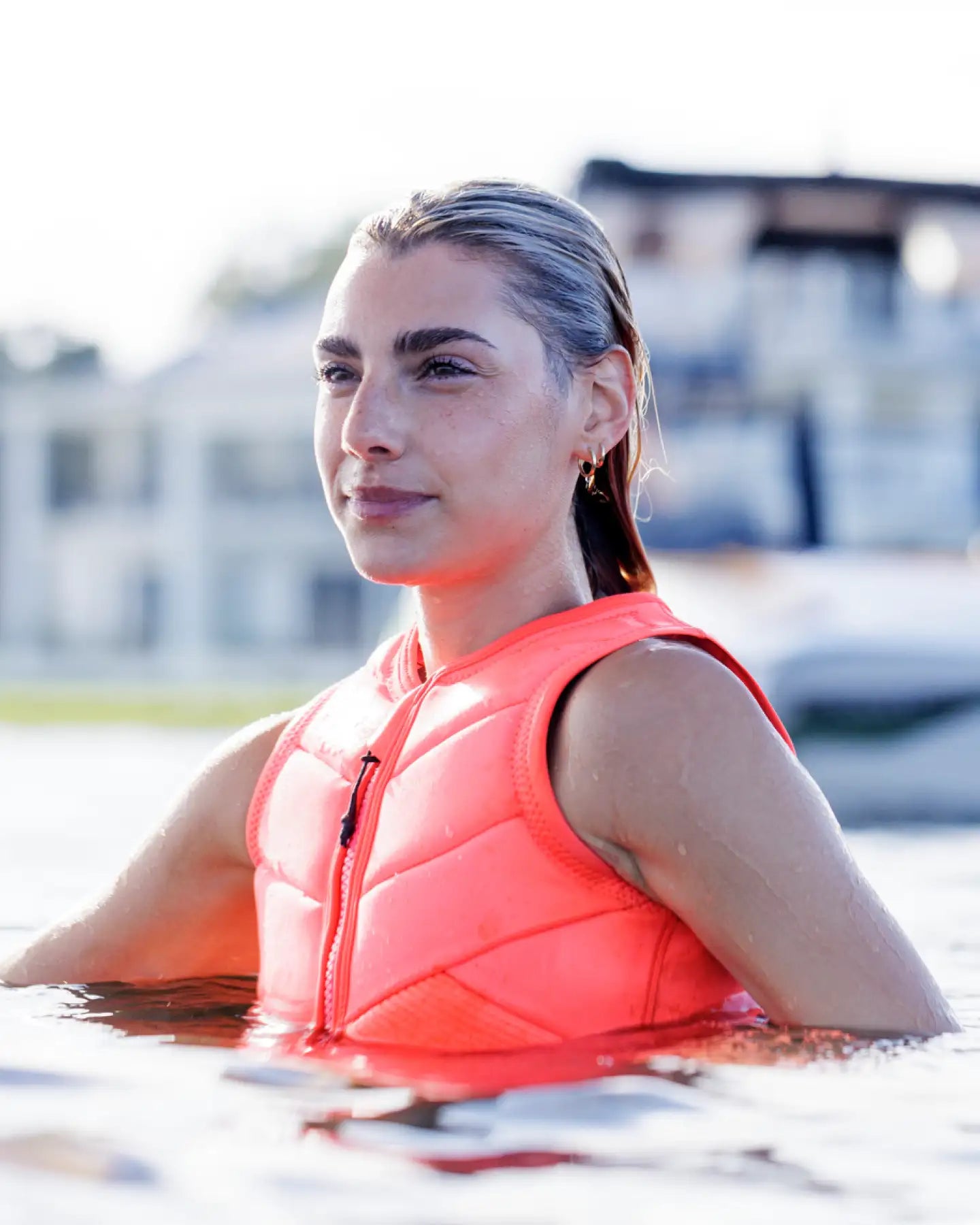 Cassidy Gale wakesurfs in the Follow Memphis Womens Impact Vest - Fluro Red