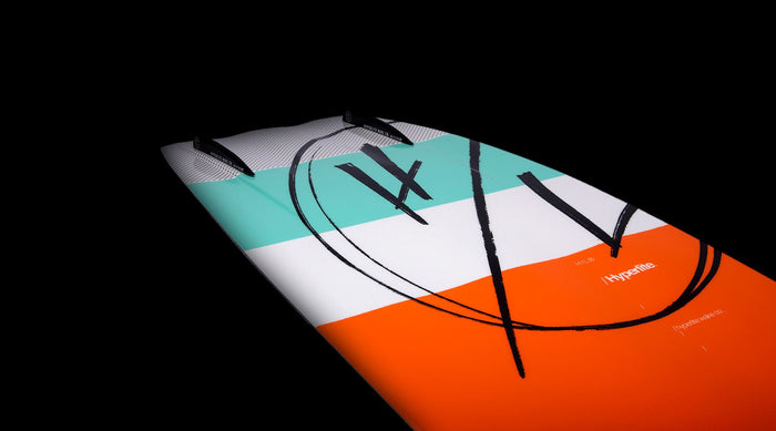 A Hyperlite 2023 Source Wakeboard | Team X Bindings with an orange and blue design on it.