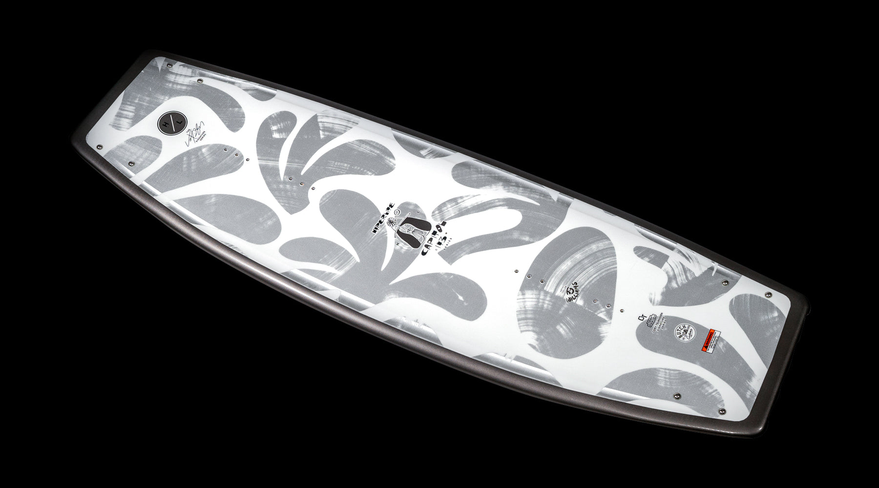 A skateboard deck boasting a monochrome abstract design with swirling patterns and diverse logos is set against a black background, evoking the elegant style of the Hyperlite 2025 Capitol Wakeboard.