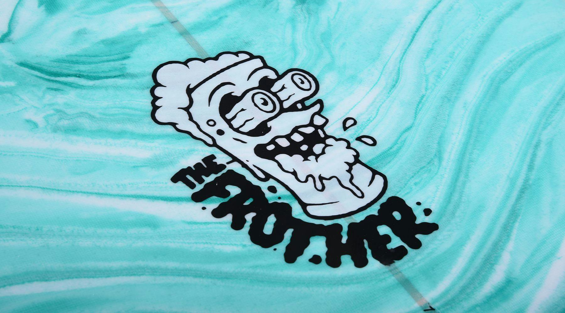 A cartoonish illustration of a frothy glass with eyes and a mouth, labeled "Hyperlite 2025 Frother 2.0 Wakesurf Board," stands proudly on a teal marble-patterned background, reminiscent of the playful style found in Hyperlite graphics.