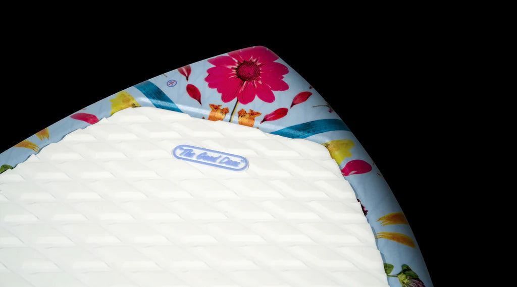 A close-up of the surfboard's tip reveals a floral design along the edges, highlighting a label that reads "The Good Knife." Perfect for wakesurf enthusiasts, the Hyperlite 2025 Good Daze Women's Wakesurf Board combines DuraShell Construction for durability and style during those memorable days on the water.