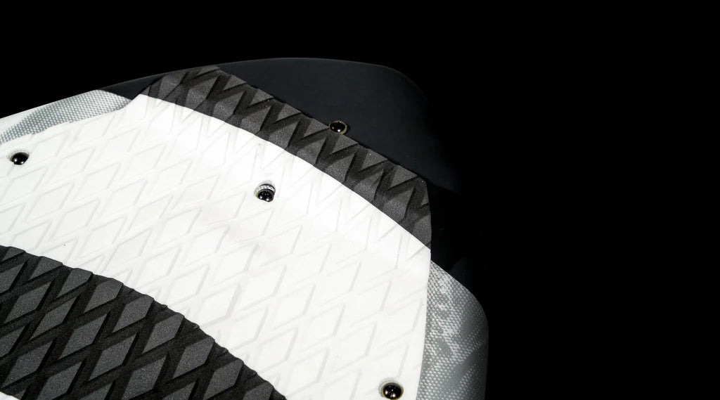 Close-up of the tail of the Hyperlite 2025 Hi-Fi Wakesurf Board, showcasing its black and white textured EVA traction pad against a black background.