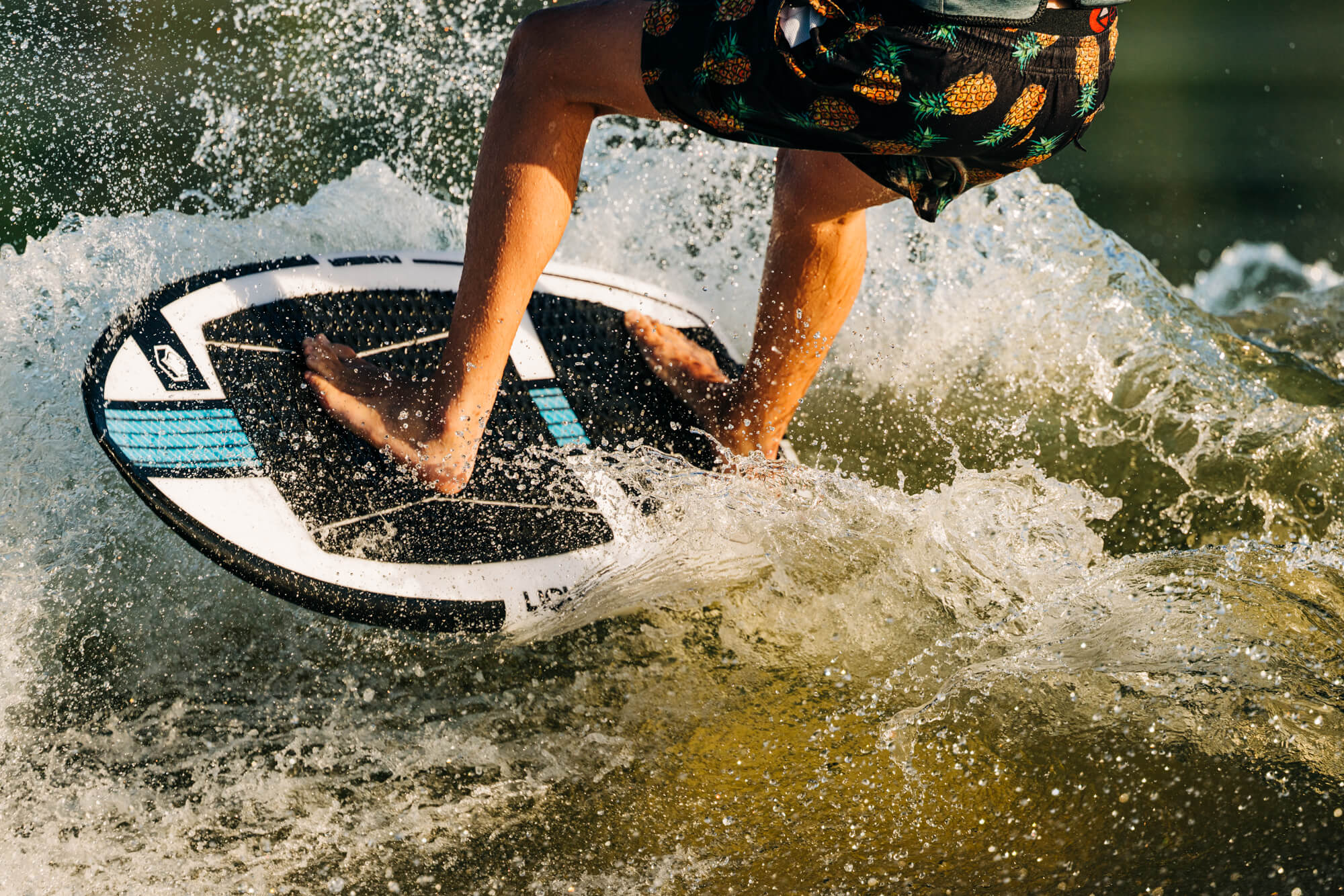 A person riding a Liquid Force 2024 Flyer Wakesurf Board (Pre-Order) with speed in the water.