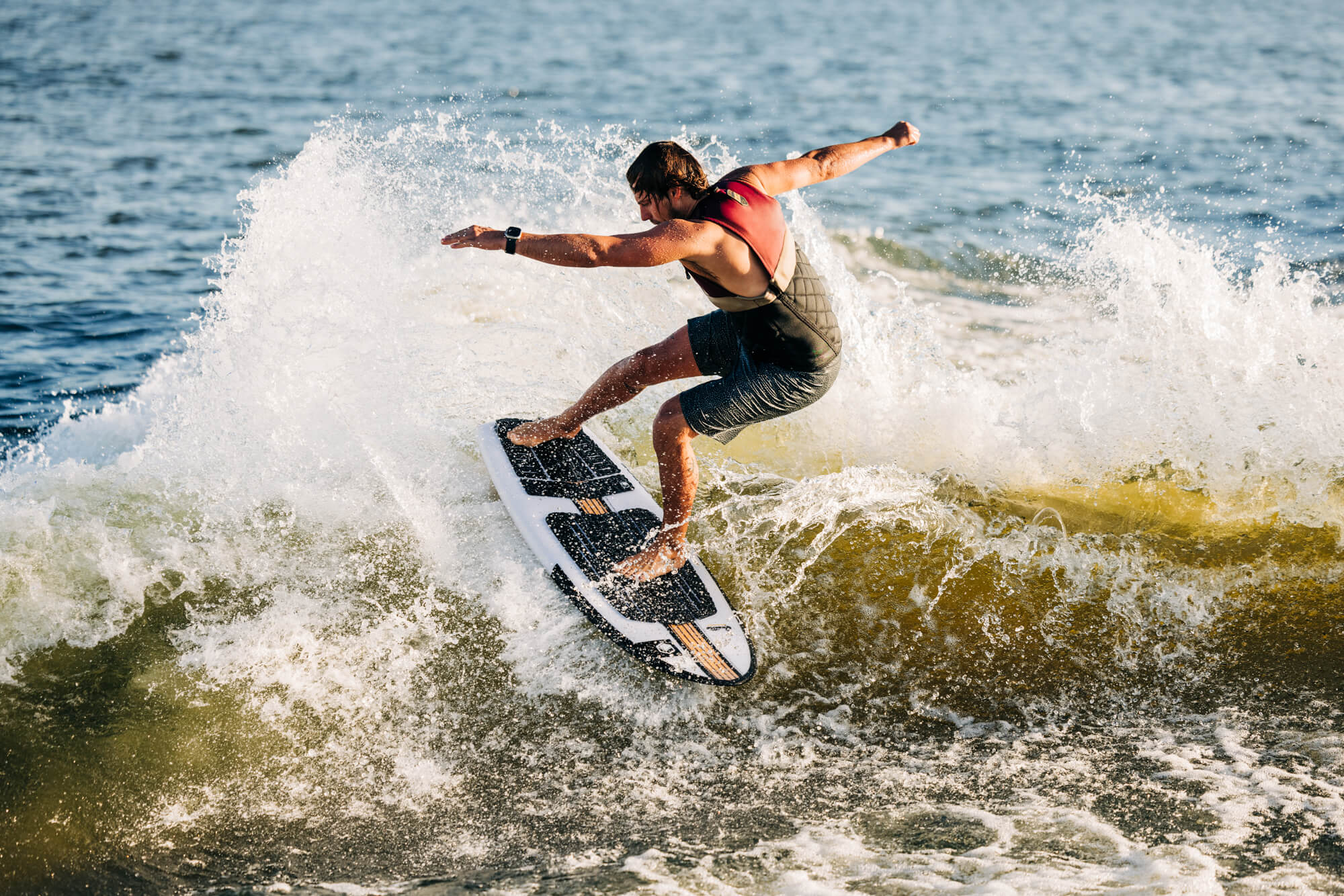 A man riding a wave on a Liquid Force 2024 Quattro Wakesurf Board (Pre-Order).