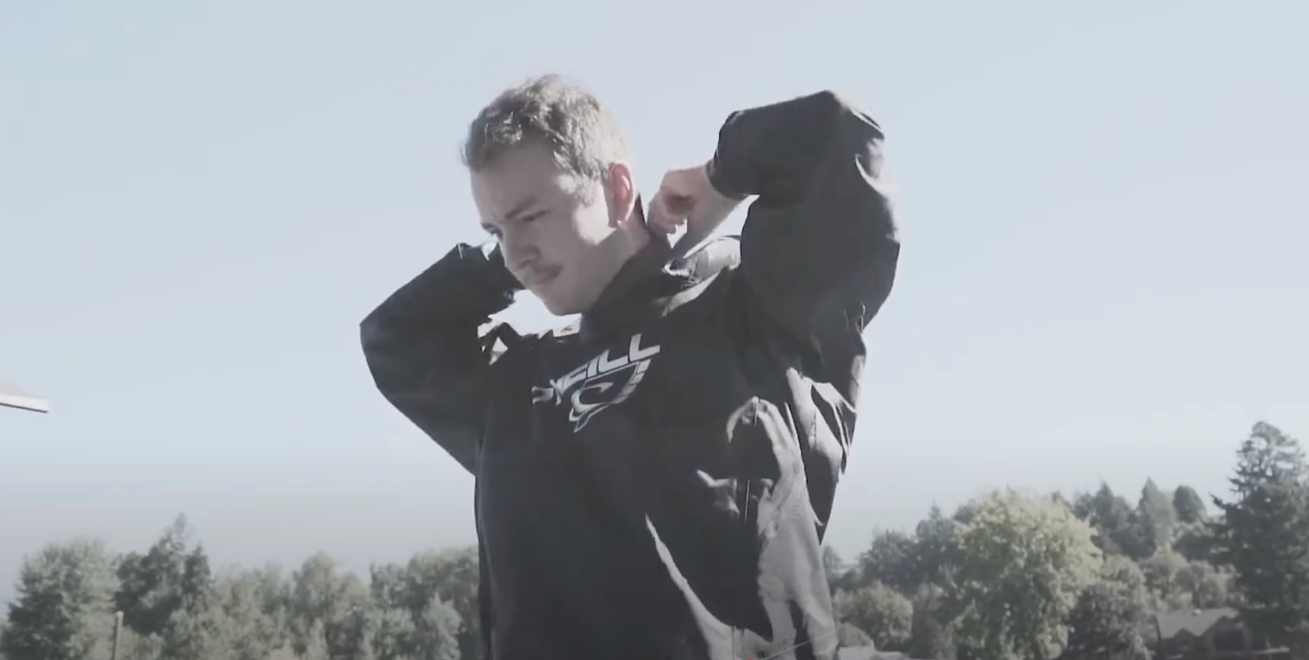 Man puts on his O'Neill Boost Drysuit 
