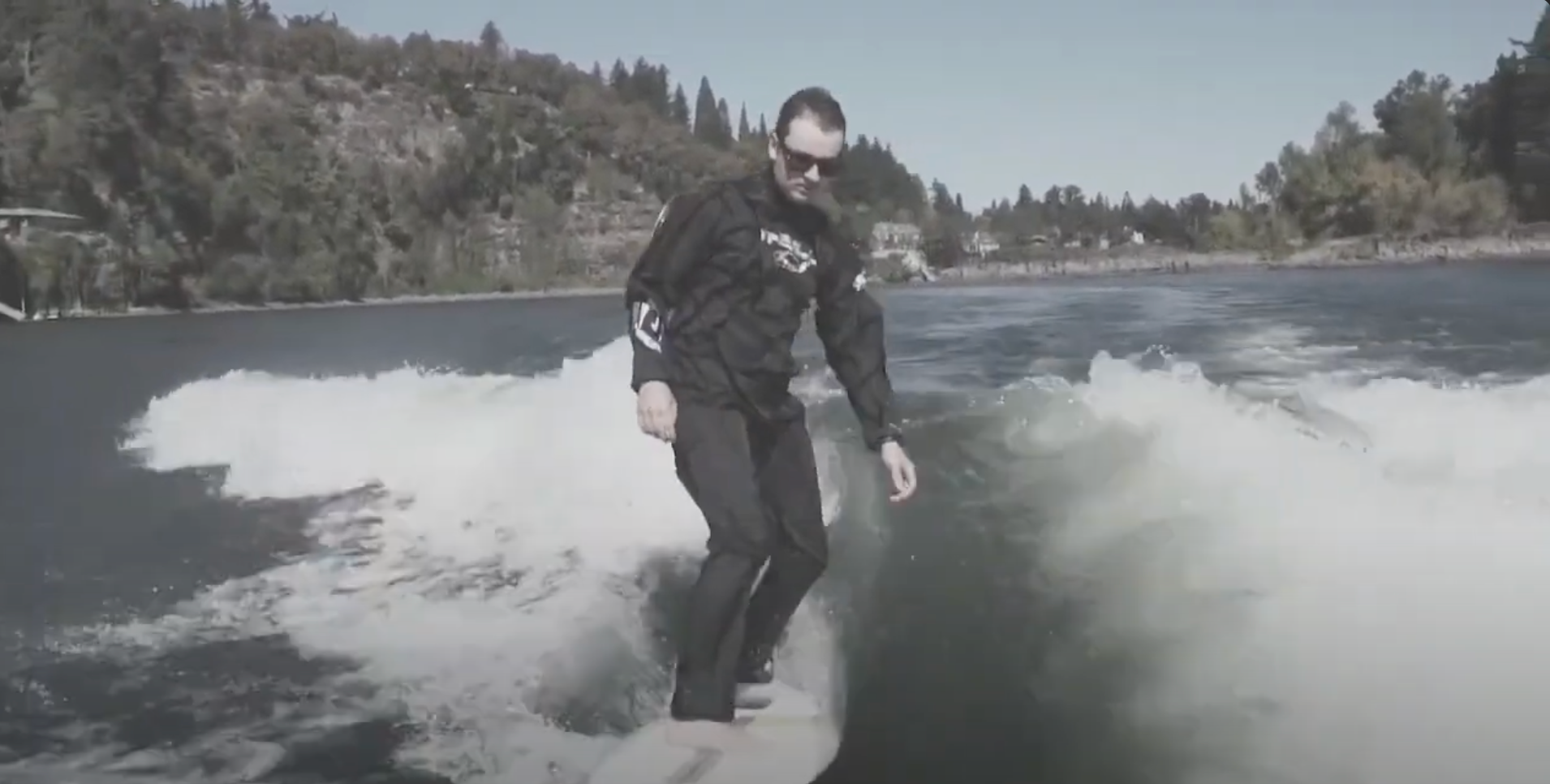 Man rides wakesurf board in the O'Neill Boost Drysuit  