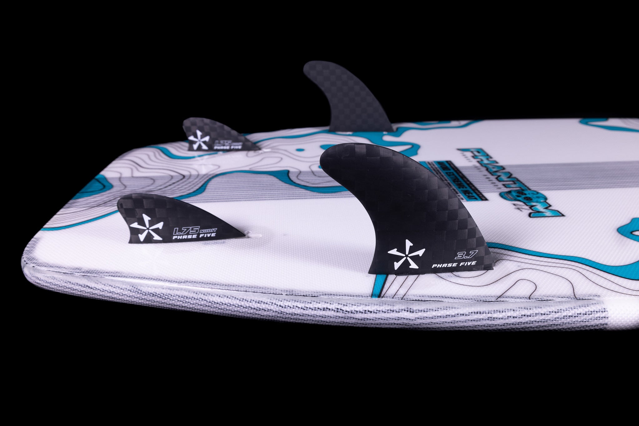 Close-up of a Phase 5 2025 Phantom Wakesurf Board with three black fins, showcasing white logos and intricate blue patterns, crafted for Parker Payne.