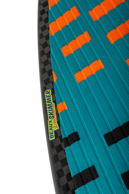 Close-up of a surfboard showcasing the dynamic black and orange checkered pattern on a blue background, adorned with the distinctive Ronix 2025 Beaux Skimmer Wakesurf Board label by Ronix.