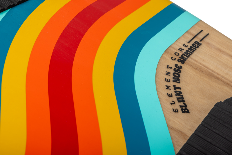 Close-up of a board featuring colorful curved stripes in red, orange, yellow, blue, and turquoise. Text reads: Ronix 2025 Element Core Blunt Nose Skimmer. Crafted with a lightweight surf core for exceptional stability.