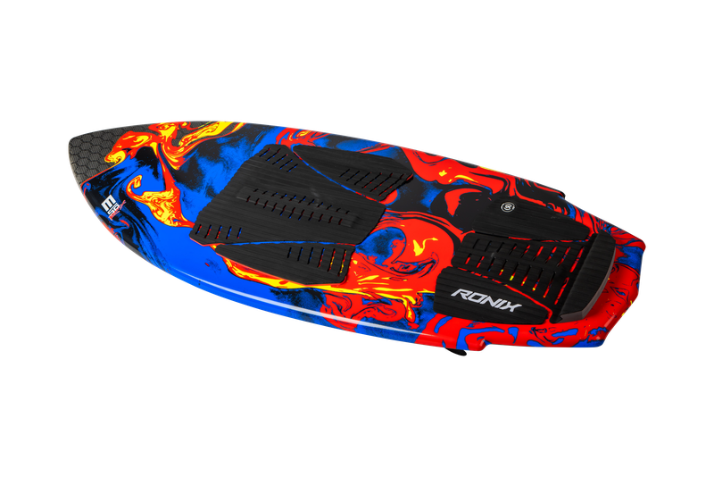 The Ronix 2025 H.O.M.E. Carbon Pro M50 Wakesurf Board boasts a vibrant red, blue, and black design, complete with textured black foot pads and the iconic white Ronix logo. Its high-end shape ensures it excels in performance across various surf conditions, making it a true quiver killer.