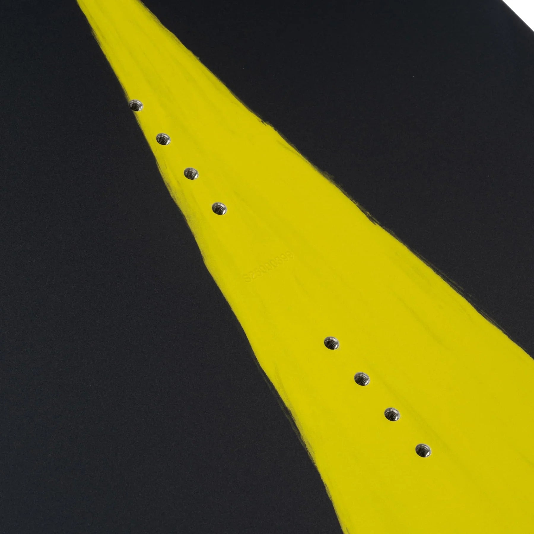 Close-up of the Slingshot 2025 Bearden Wakeboard, showcasing a distinctive yellow stripe in the center and multiple binding holes arranged in two rows, set against a dark background. This dynamic wakeboard offers soft flex and chined rails for superior performance on the water.