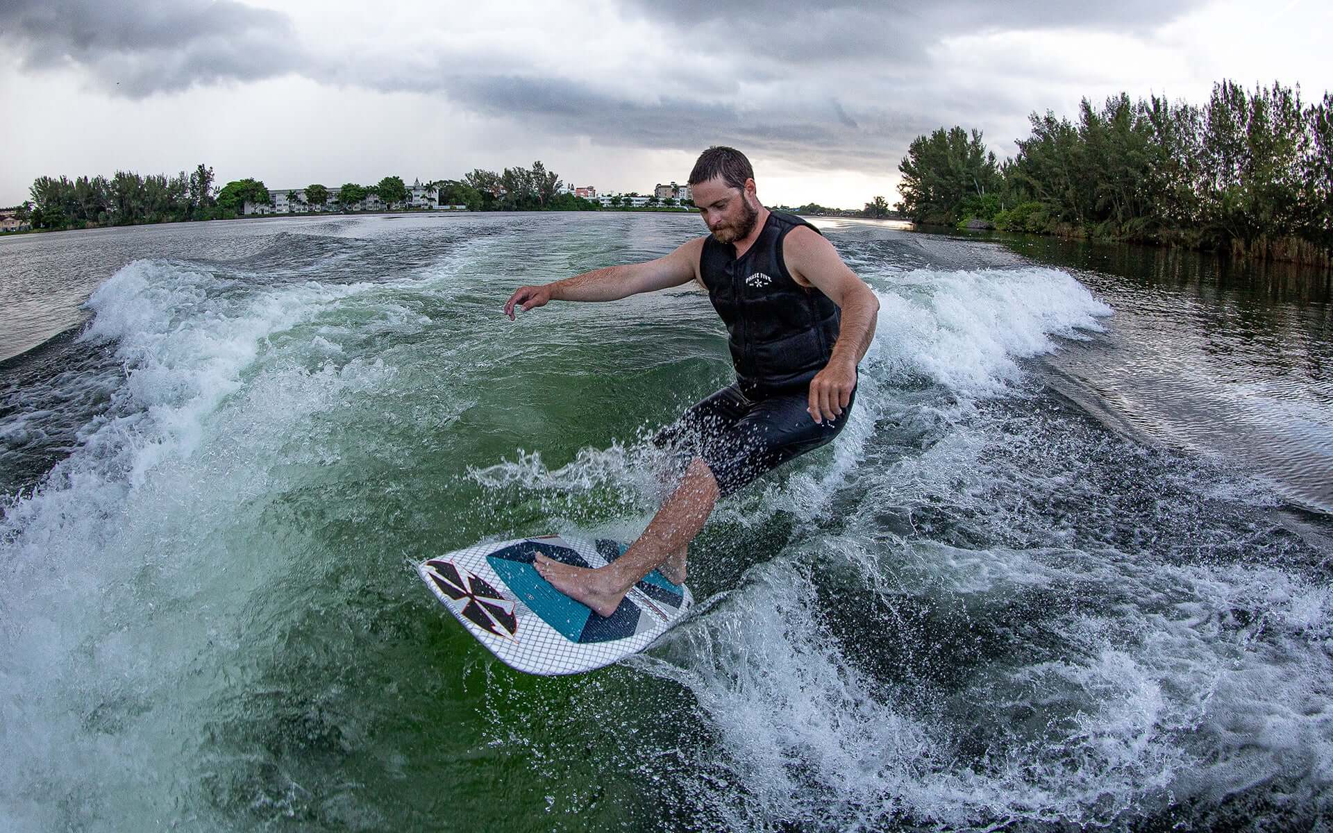 An experienced rider demonstrating stability and board control while riding a wave on a Phase 5 2024 Doctor Wakesurf Board.
