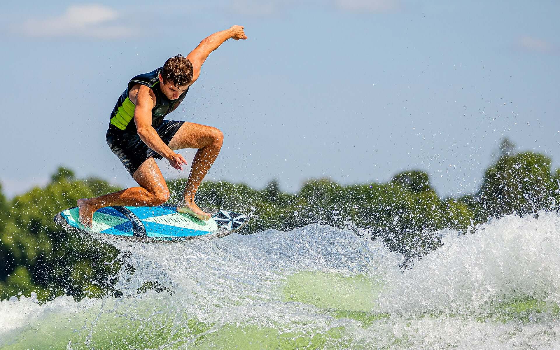 A man is riding a wave on a Phase 5 2024 Matrix Payne Pro Wakesurf Board, showcasing incredible performance.