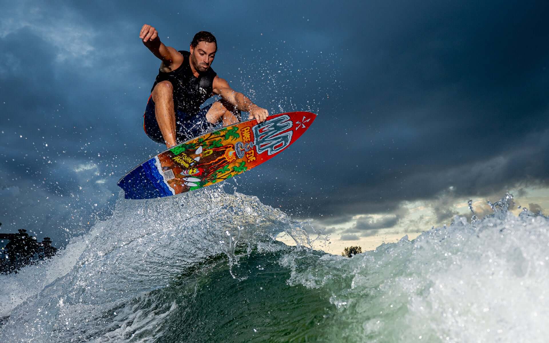 A man skim style riding a surfboard on a wave with the Phase 5 2024 MVP LTD Wakesurf Board.