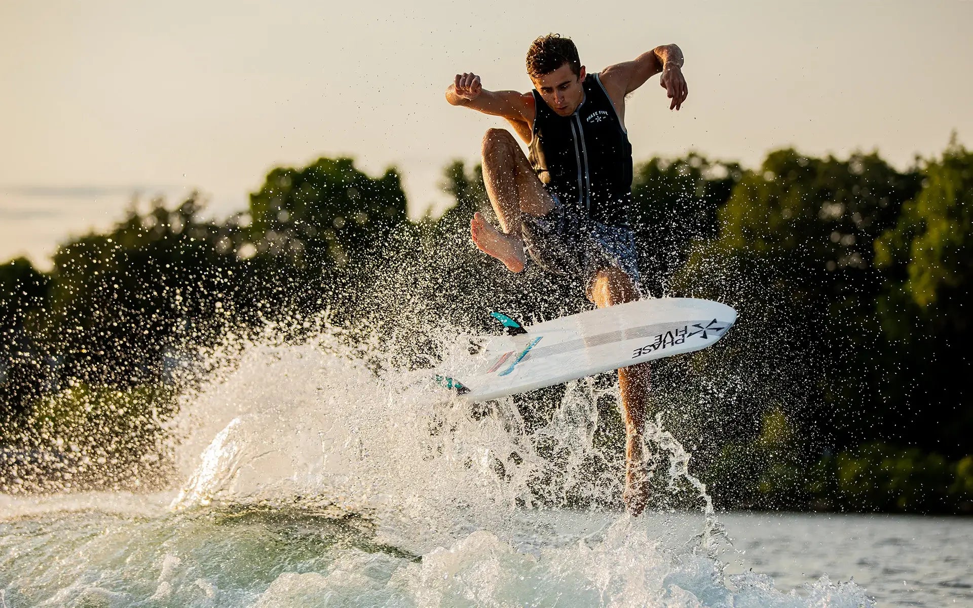 Parker Payne, the Phase 5 surfer, effortlessly rides a Phase 5 2024 Phantom Wakesurf Board through the air.