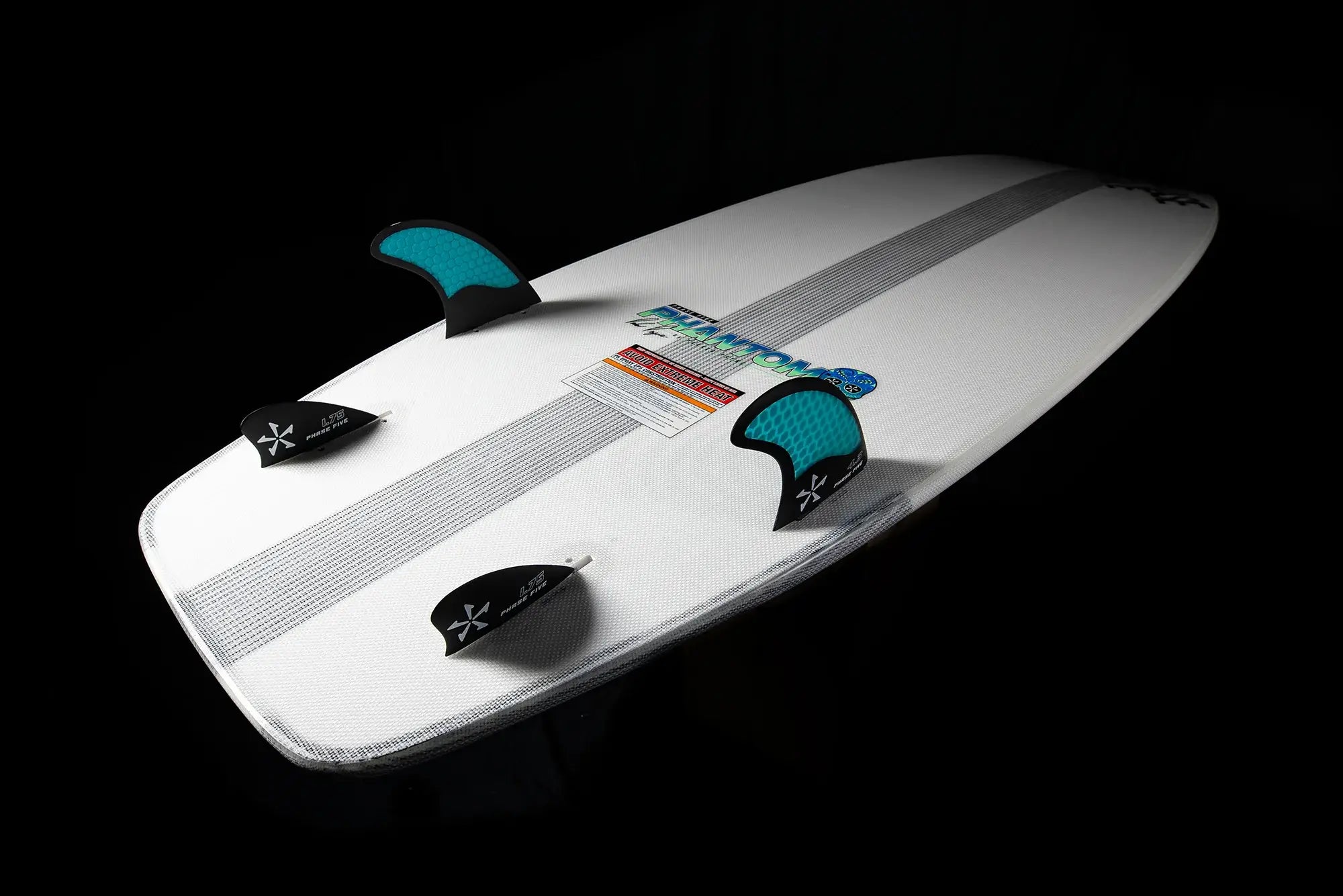 A white Phase 5 surfboard with two Phase 5 Phantom fins, designed by Parker Payne.