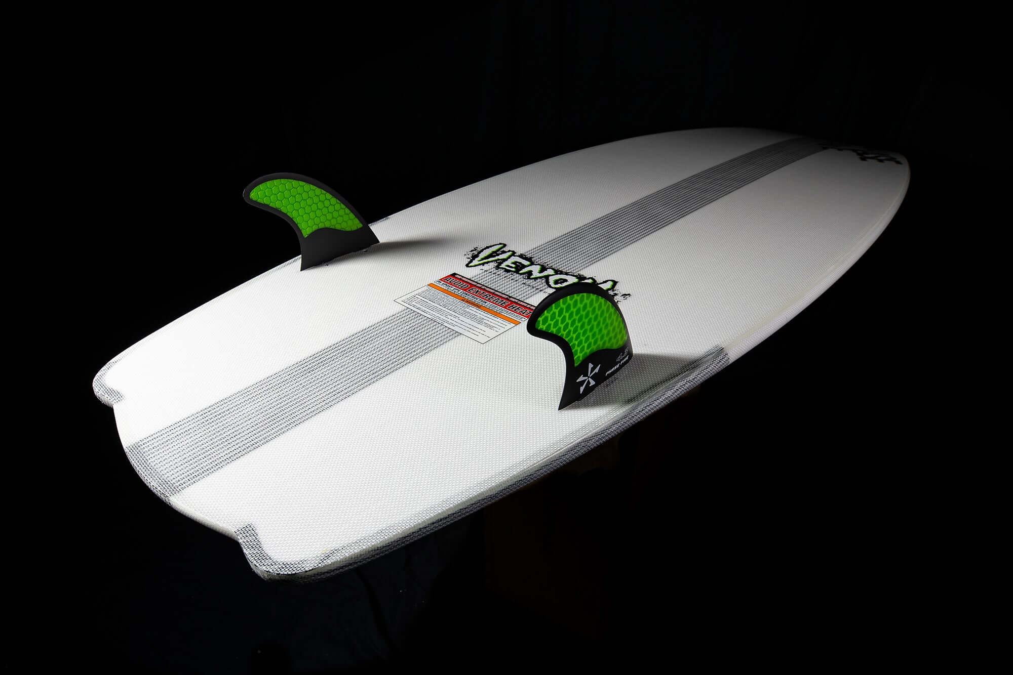 A Phase 5 2024 Venom Wakesurf Board with green fins on it.