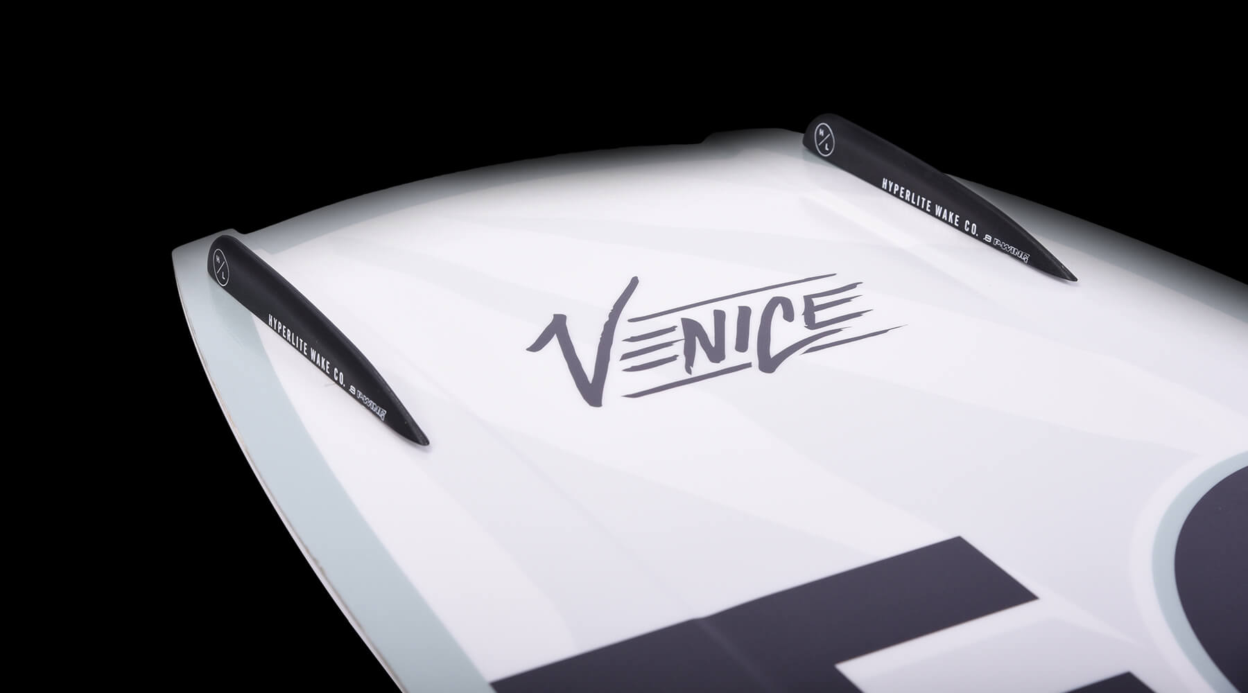 A white surfboard with the word Venice on it, perfect for riding the waves of the Hyperlite 2024 Venice Wakeboard by Hyperlite.