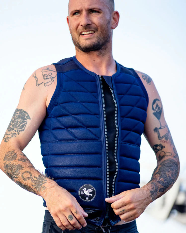A comfortable man with tattoos wearing a durable Follow 2022 BP Pro Men's Jacket - Navy by Follow Wake.