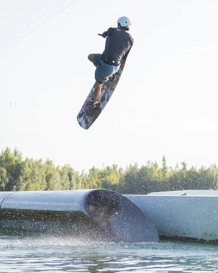 A person performing awe-inspiring tricks while skateboarding through the air wearing the Follow 2022 F#*FED Men's Jacket - Black by Follow Wake.