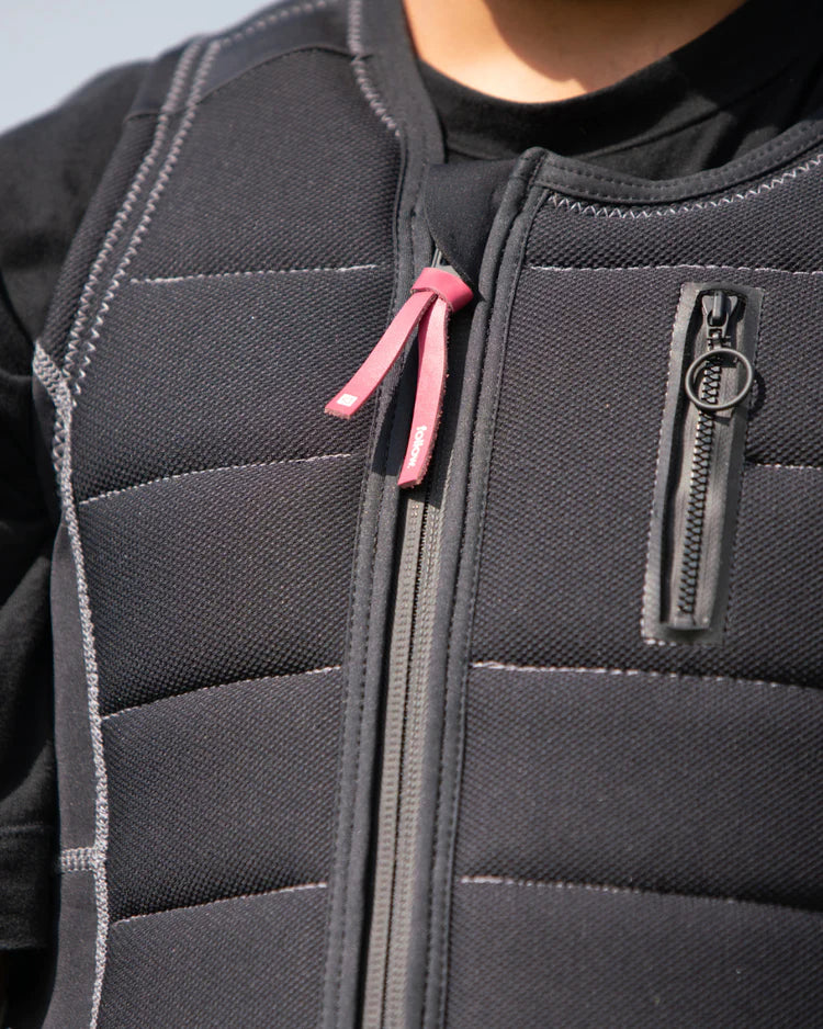 A person wearing a Follow 2022 TBA Men's Jacket - Black with a pink zipper for TrueFit fitness activities.