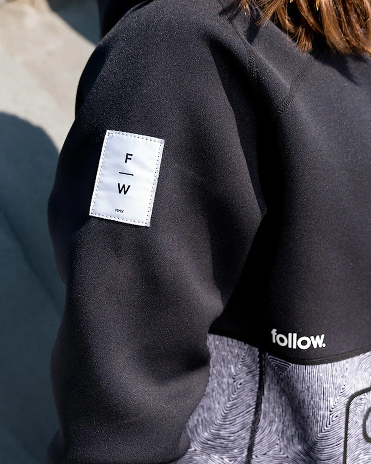 The Follow Wake woman's jacket with the word "follow" on it features Aquaguard® Stash pockets, perfect for protecting belongings from the wind chill factor.