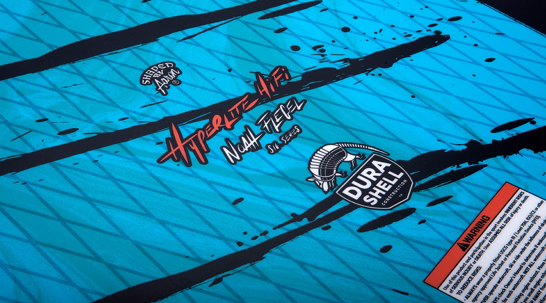 A close up of a Hyperlite 2023 Hi-Fi Wakesurf Board with black writing on it featuring the keywords "DuraShell construction" or "Machined EVA Traction pad".