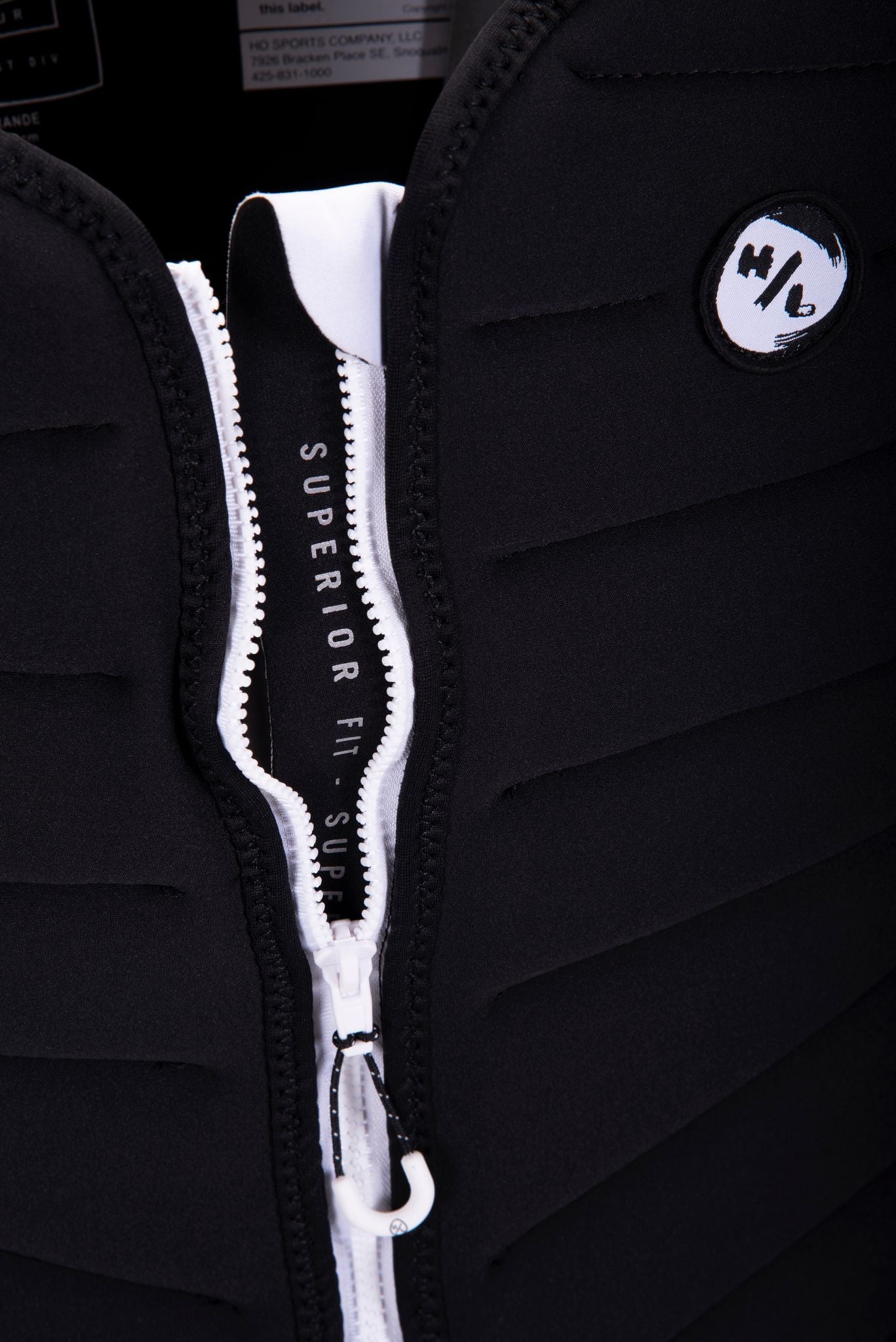 A close up of a black zippered Hyperlite 2024 NCGA Blueprint vest with white zippers, known as the Impact Jacket.