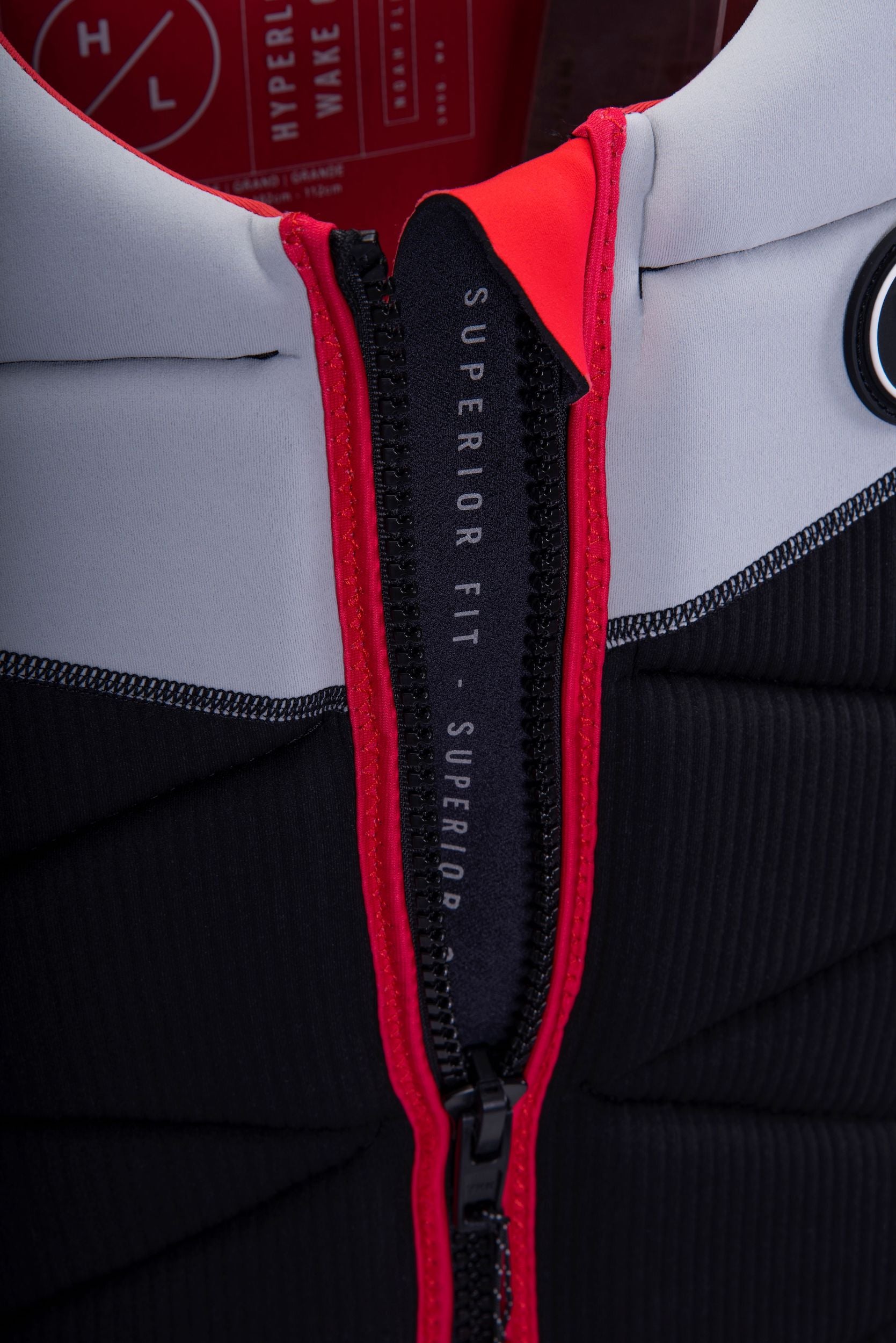 A close up of a lightweight black and red Hyperlite 2024 NCGA Riot Vest offering protection.