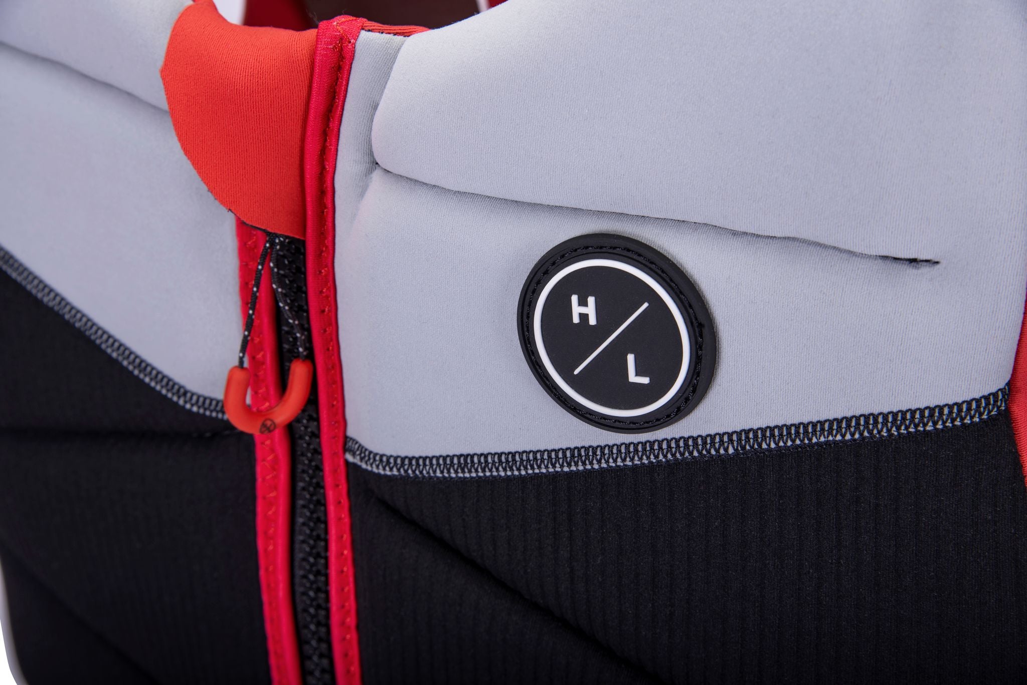 A close up of a Hyperlite lightweight black and red jacket with a zipper.