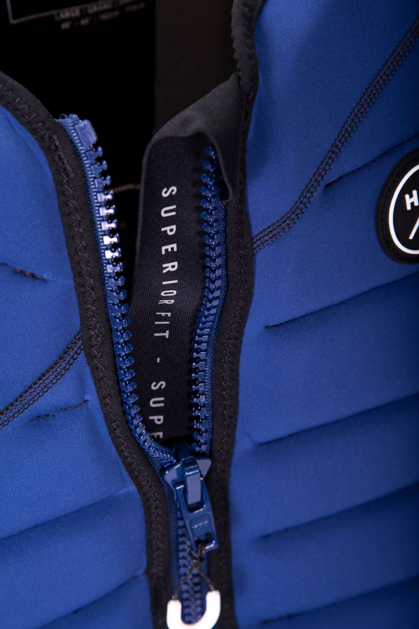 A blue zippered jacket with the word Hyperlite on it, perfect for wakeboarders.