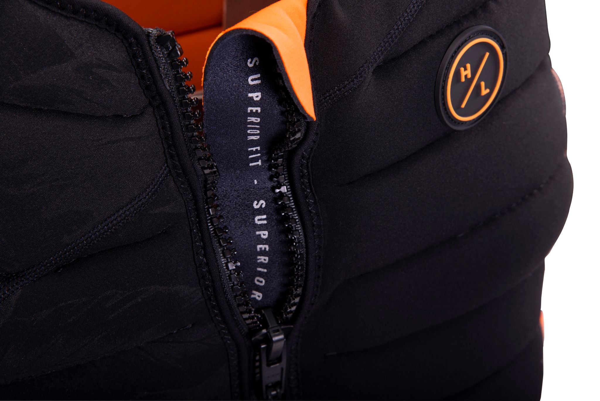 A black and orange Hyperlite Women's Cadence Vest with a zipper for a slim look.