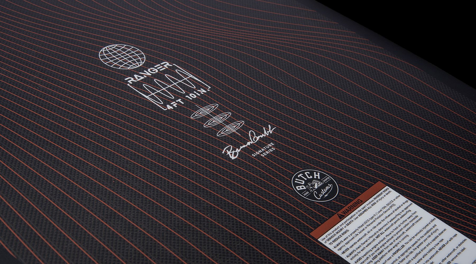 A close up of a black and orange Hyperlite 2023 Ranger Wakesurf Board featuring Durashell construction.