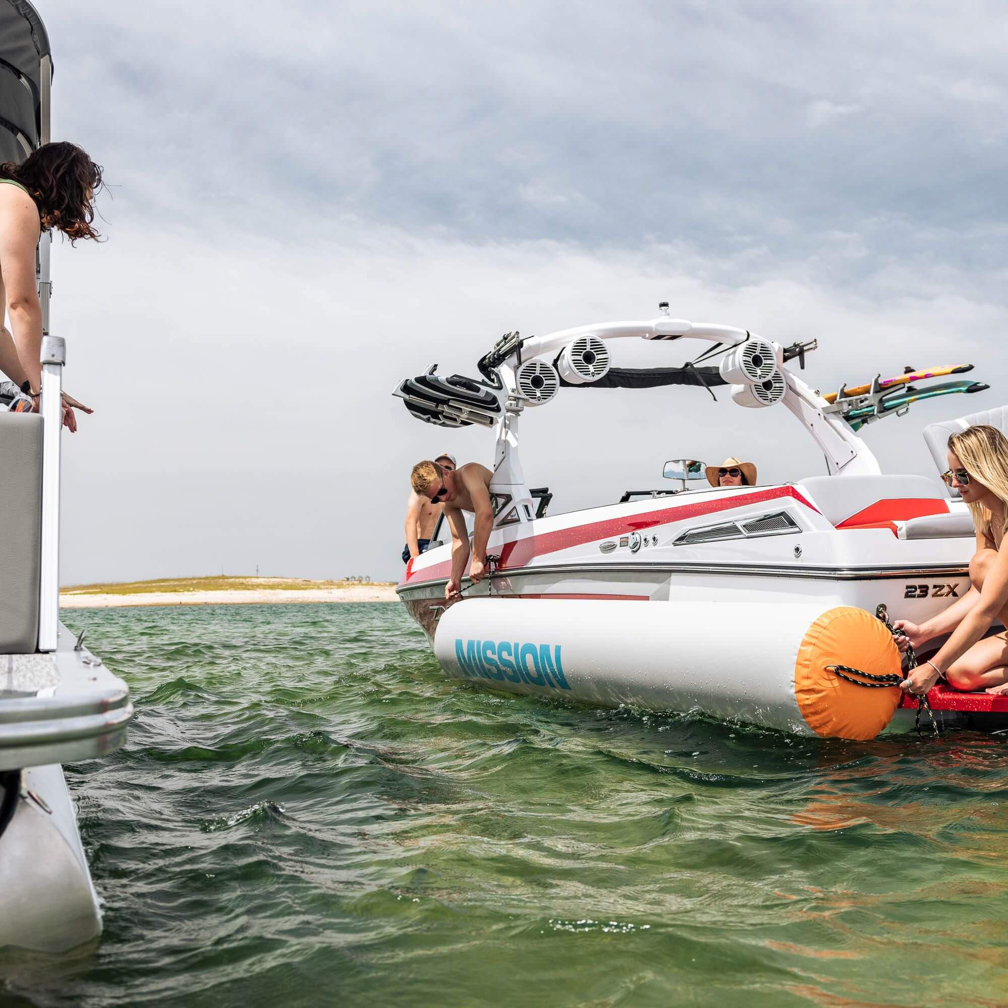 A group of people are standing on a boat, using MISSION Titan Boat Tie-Up Fenders for tie-ups.