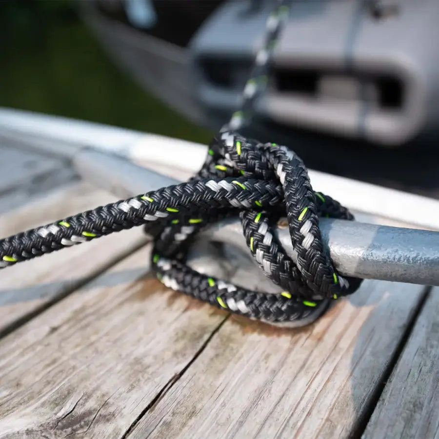 A double braided, high strength Mission Dock Lines rope tied to a wooden boat.